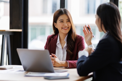 Asian Woman talking to another lady