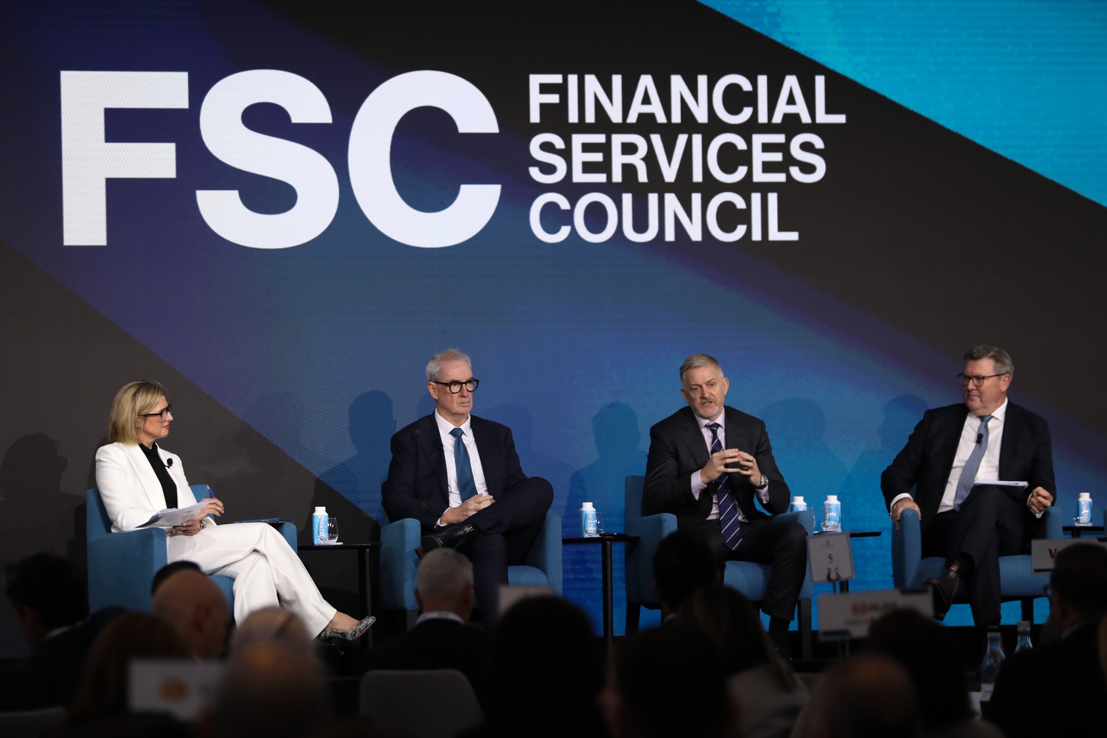 FSC panel discussion on stage at a Shaping Advice event, four speakers seated in front of the FSC logo